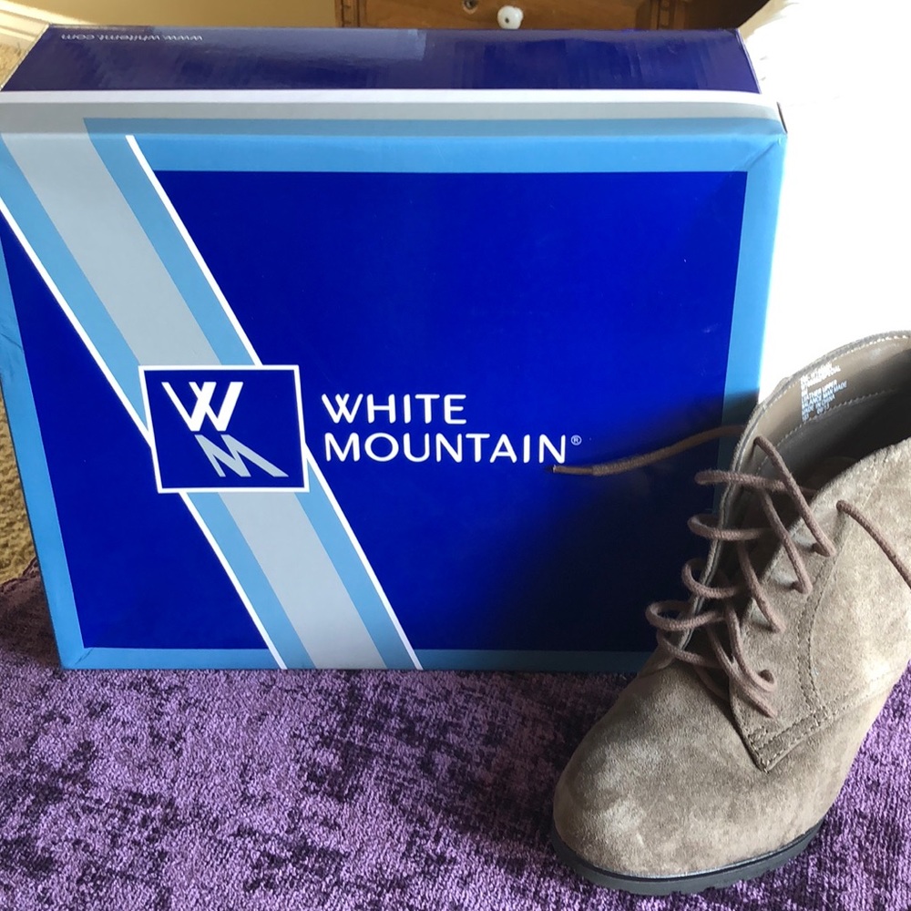 Brownish grayish heeled boots.